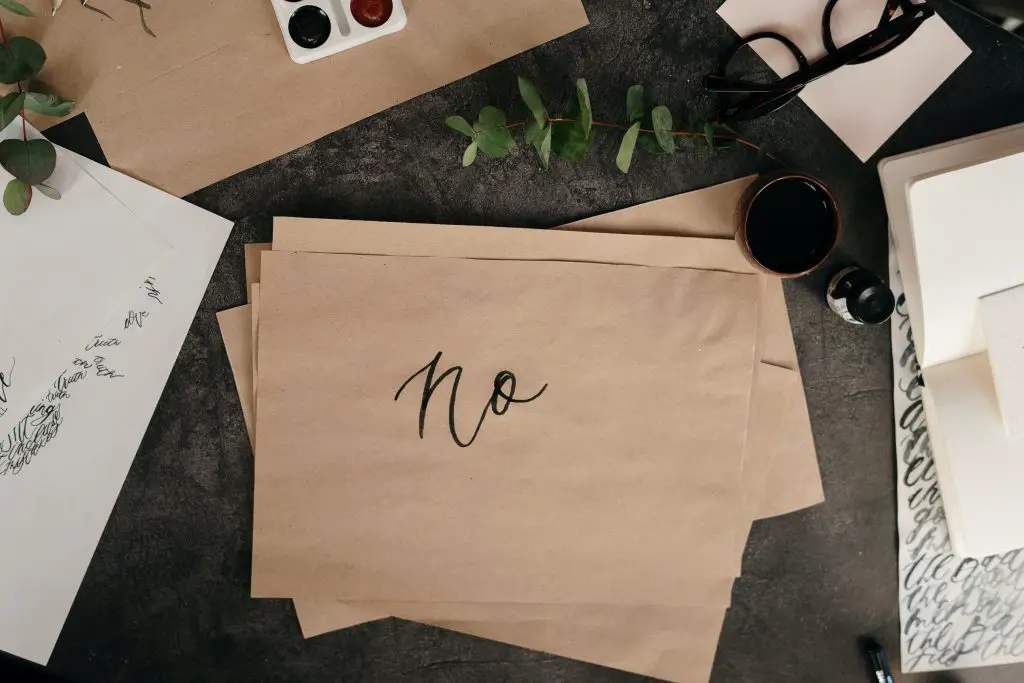brown paper with handwritten text saying no