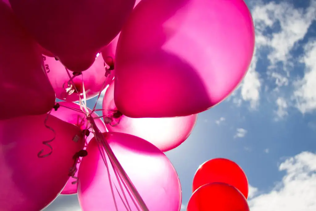 red and pink balloons in front of blue sky