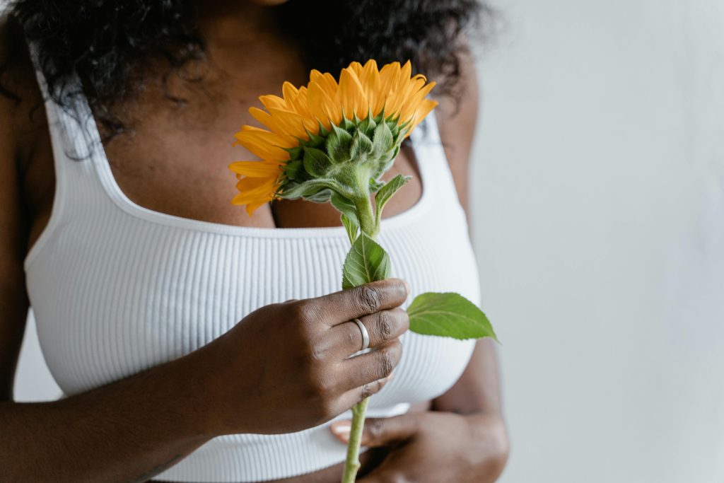 Woman-in-White-Tank-Top Holding-Sunflower