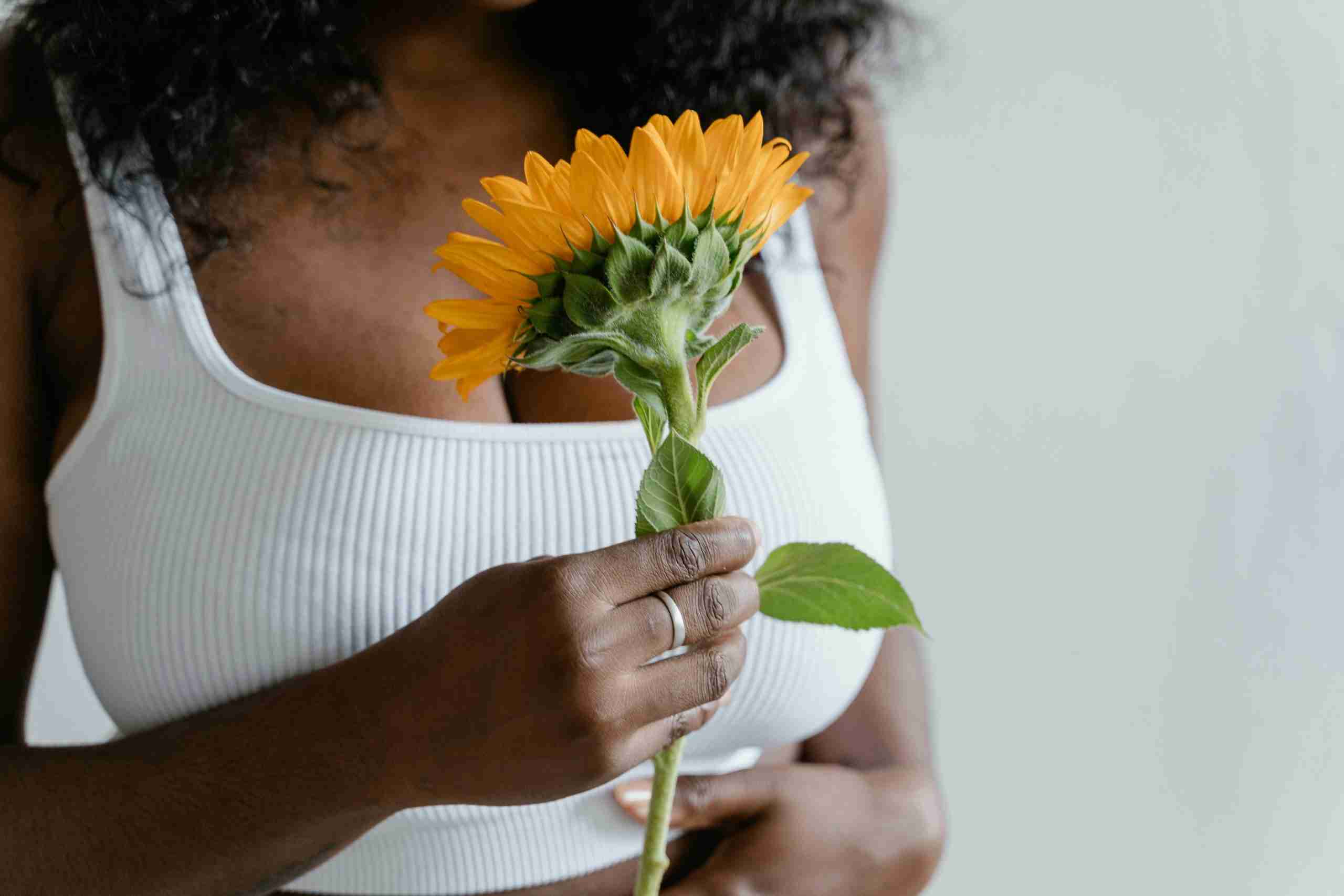 Woman-in-White-Tank-Top Holding-Sunflower