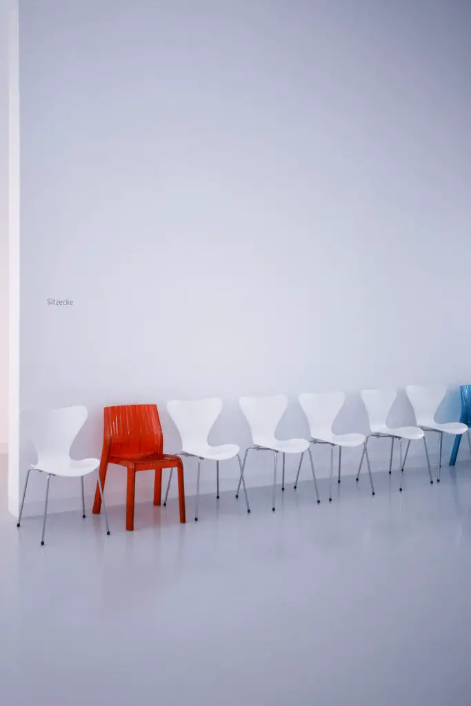 vacant red and white chairs in a room