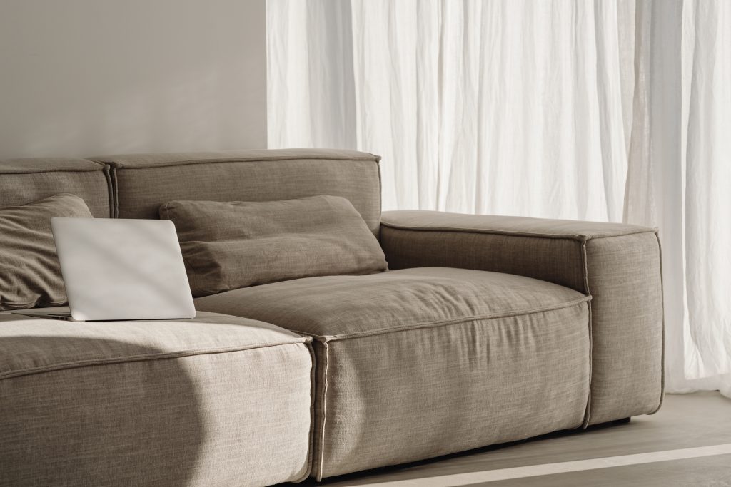 laptop sitting on beige sofa