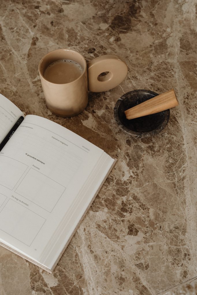 book and cofee on brown marble worktop