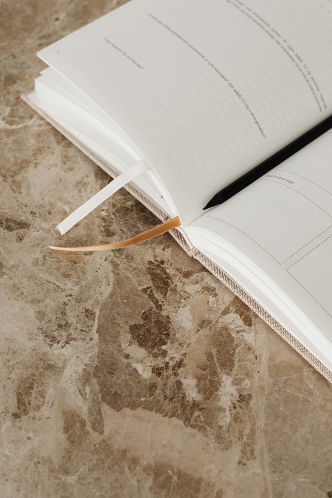 planner on brown marble counter top