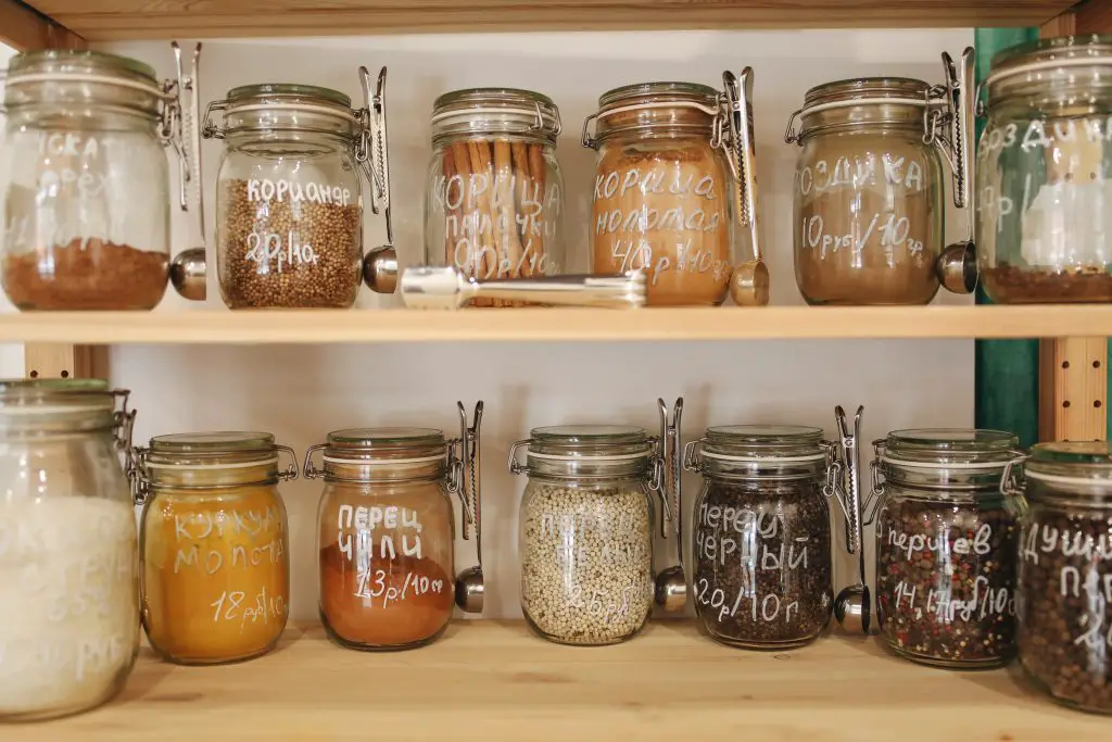 clear glass jar on wooden shelf
