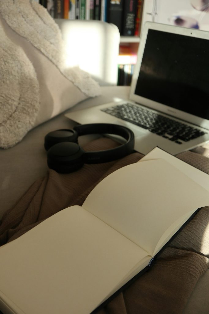 Cozy Workspace with Open Notebook and Headphones