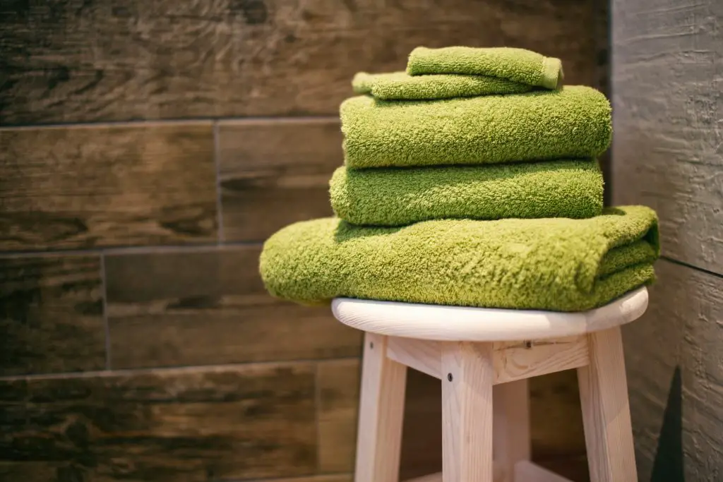 green towels on wooden chair