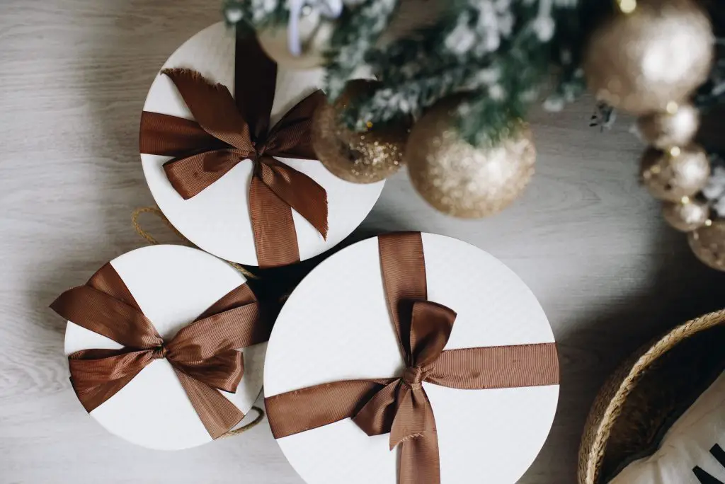 brown and white gifts under Christmas tree