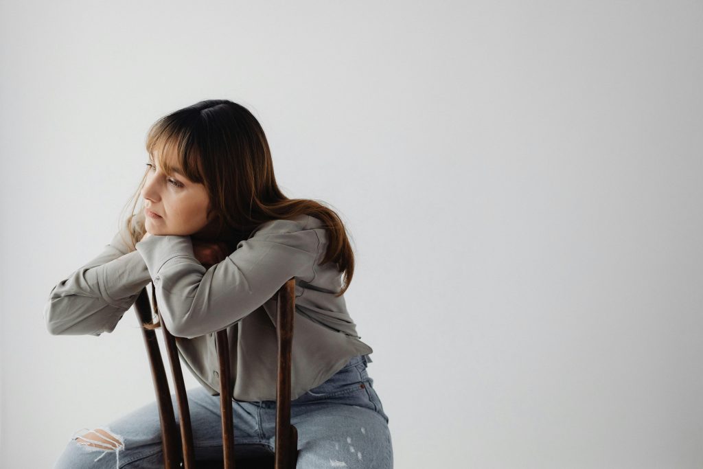 Photo of a Woman against a White Wall
