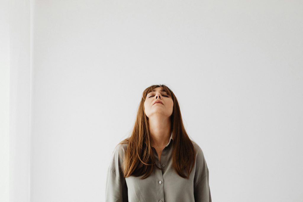 Photo of a Woman against a White Wall
