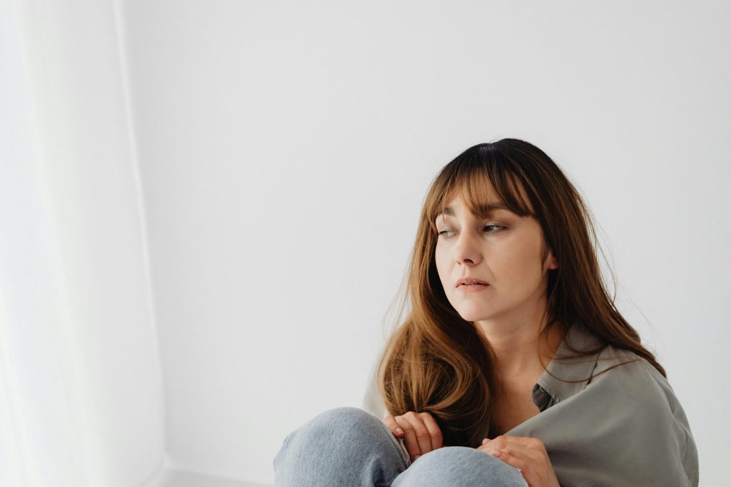 Photo of a Woman against a White Wall

