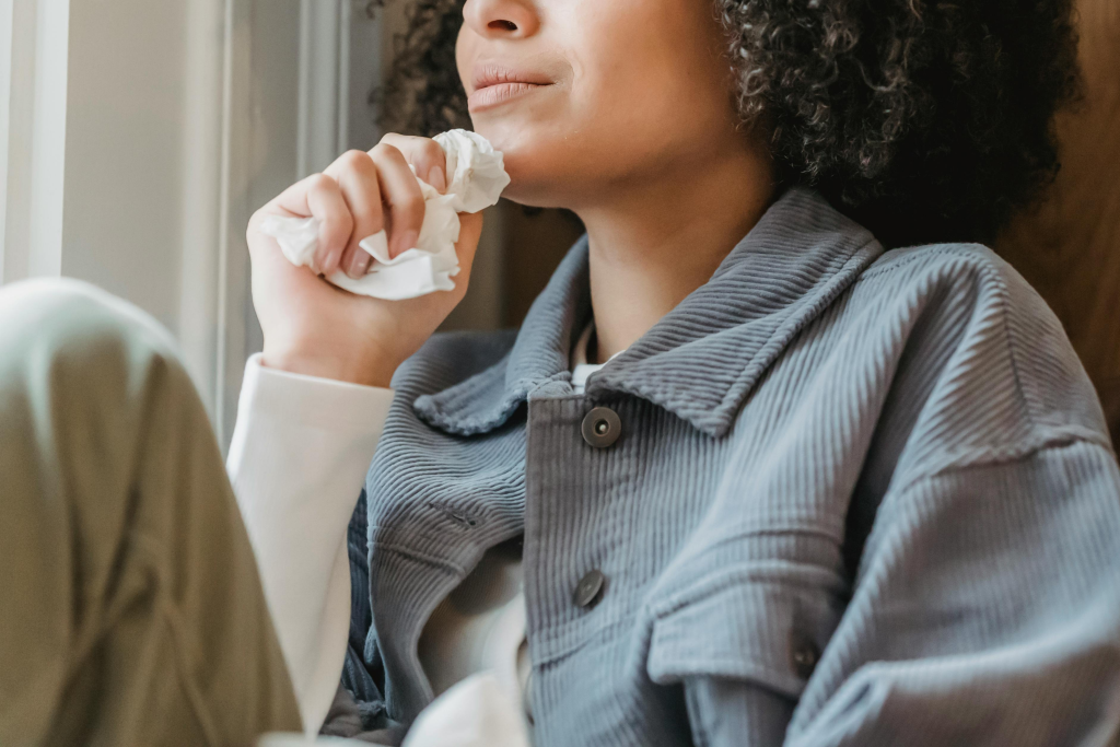 thoughtful-young-ethnic-lady-crying-near-window-at-home