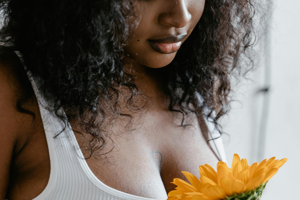 Woman-in-White-Tank-Top-Holding-Sunflower