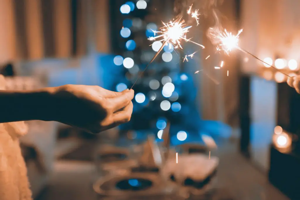 close up of two people holding sparklers.jpg