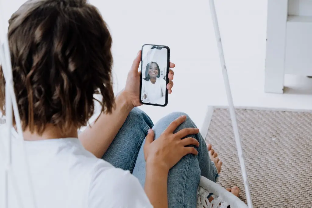 woman in white shirt on facetime call.
