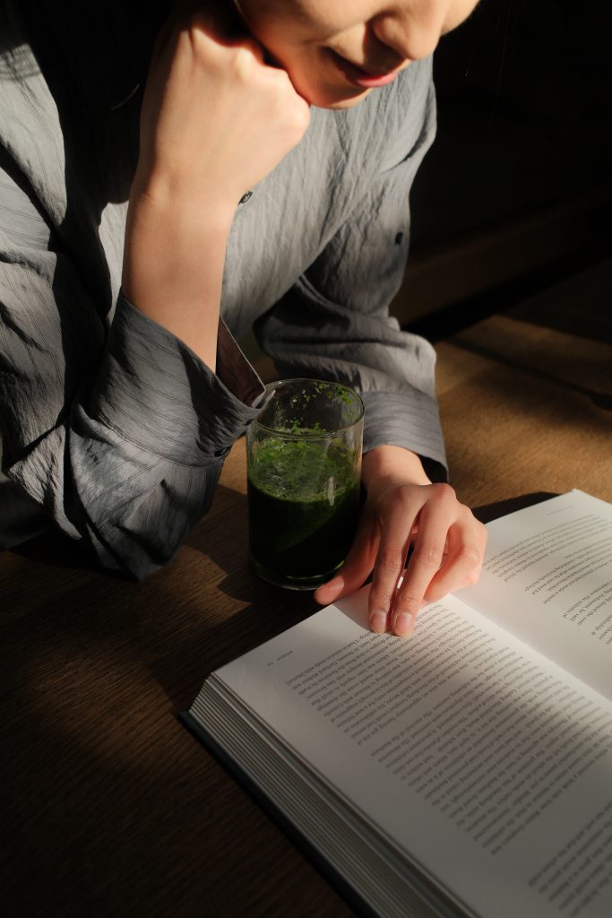 woman at desk reading book