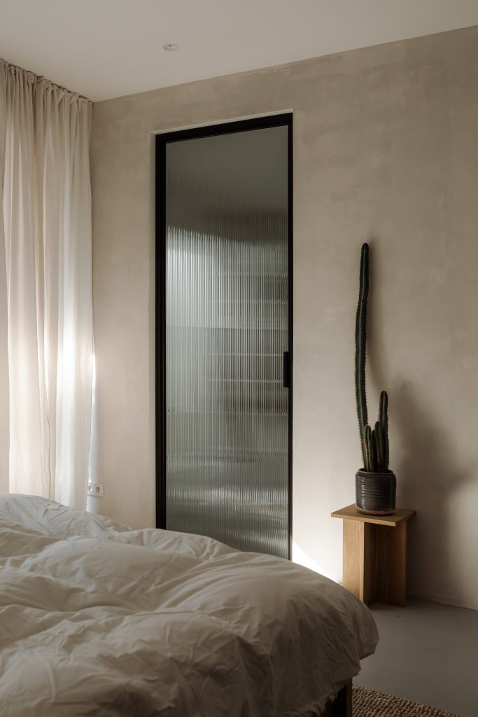 cactud beside mirror and white curtains window