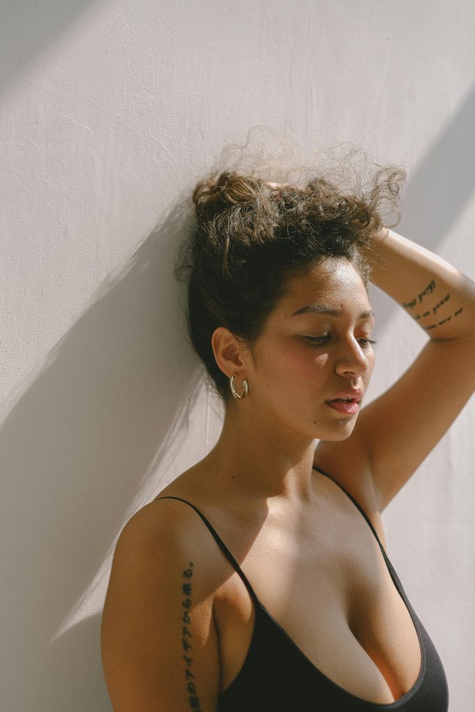 woman closing eyes holding hair up