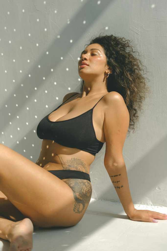 woman in black bikini sitting on floor