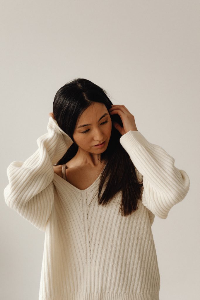 woman in cream sweater
