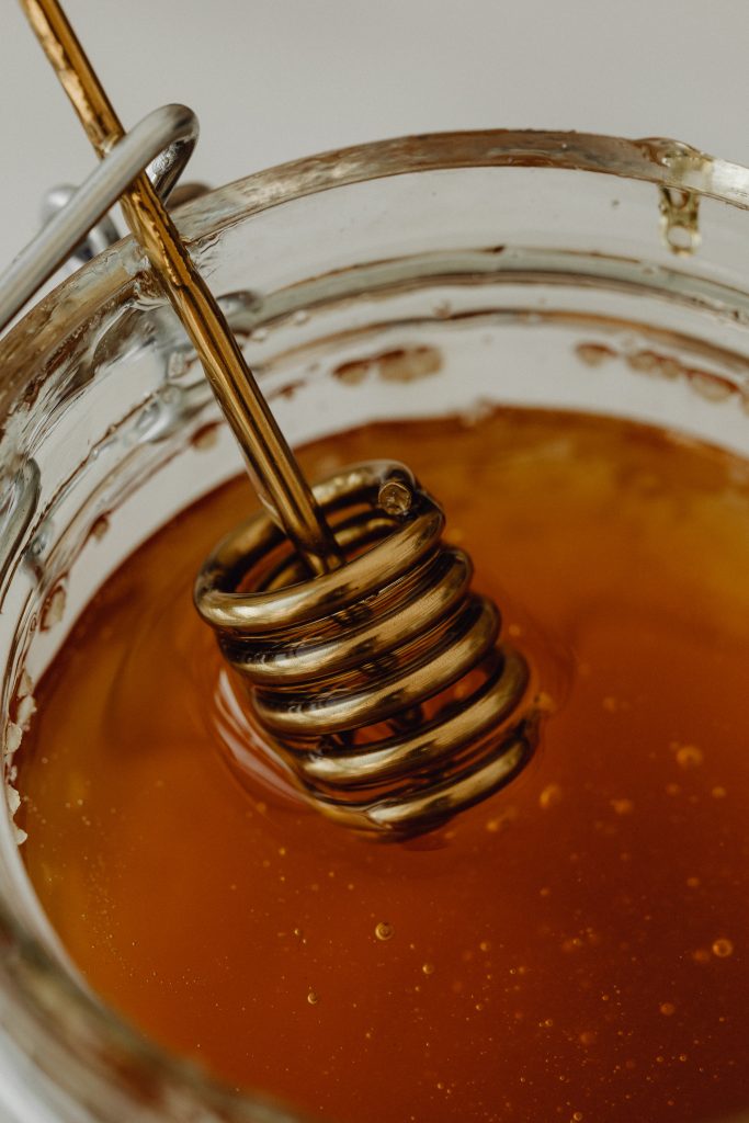 honey in honey jar and a spoon