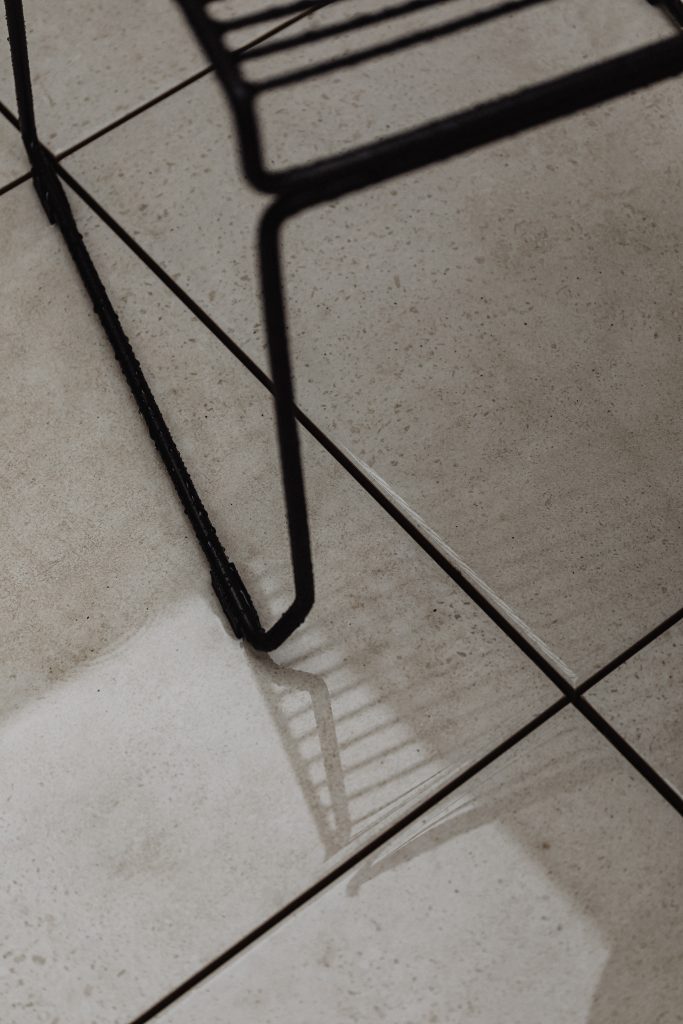 corner of black chair on concerete floor