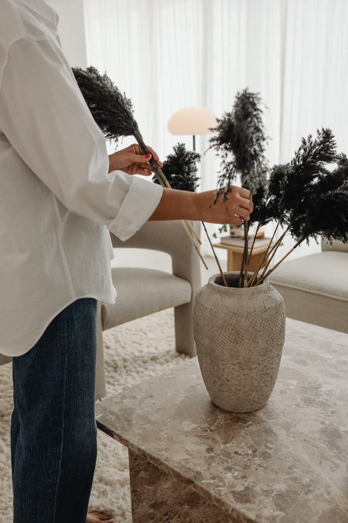 woman arraging plant in flower pot