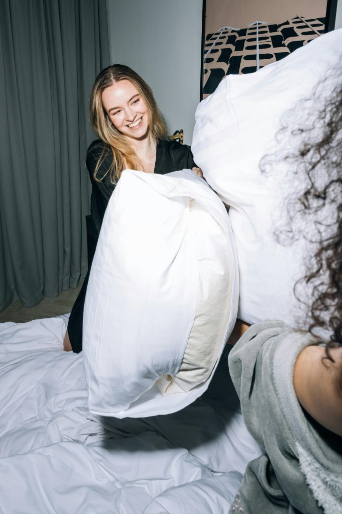 two women having a pillow fight
