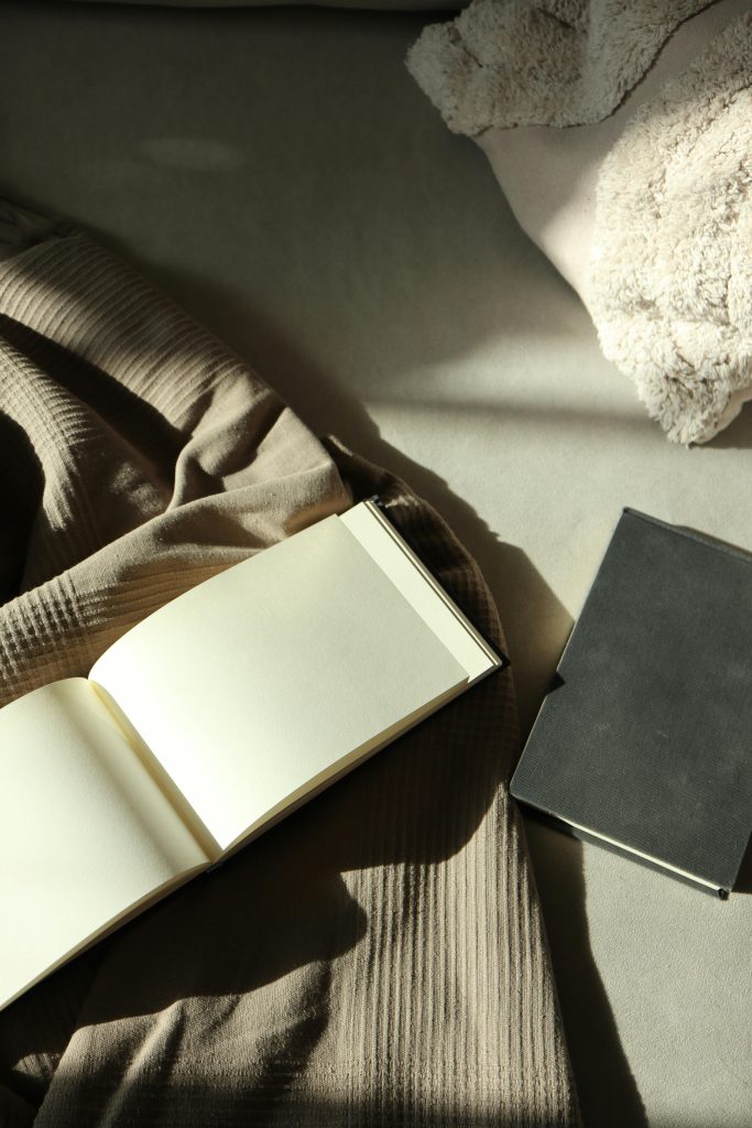 open notebook on grey throw on couch