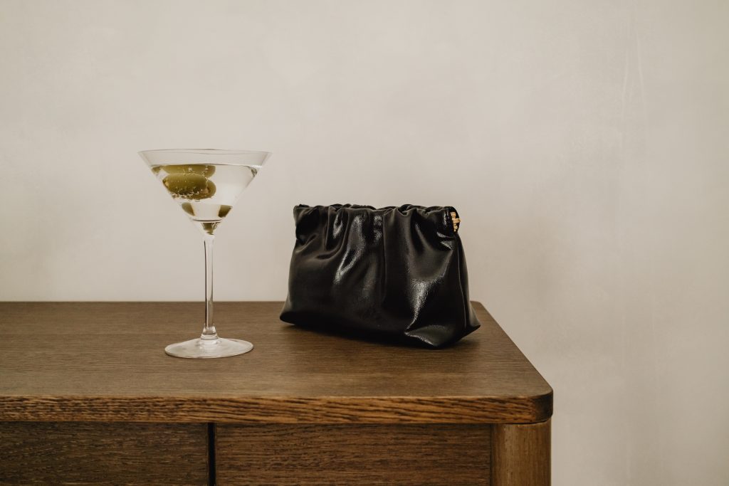 martini beside black bag