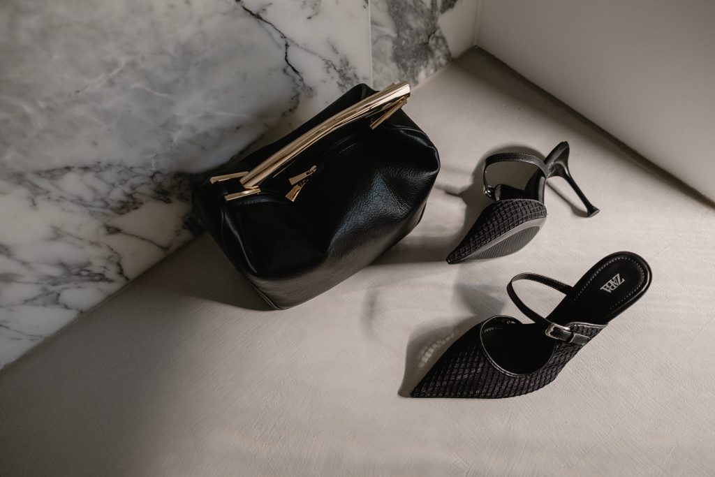 black heels beside black bag