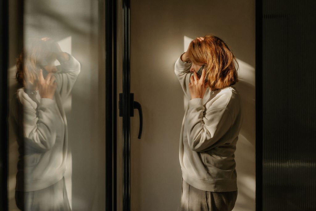 WOMAN LOOKING OUT OF WINDOW