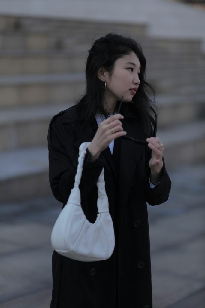 woman with white handbag