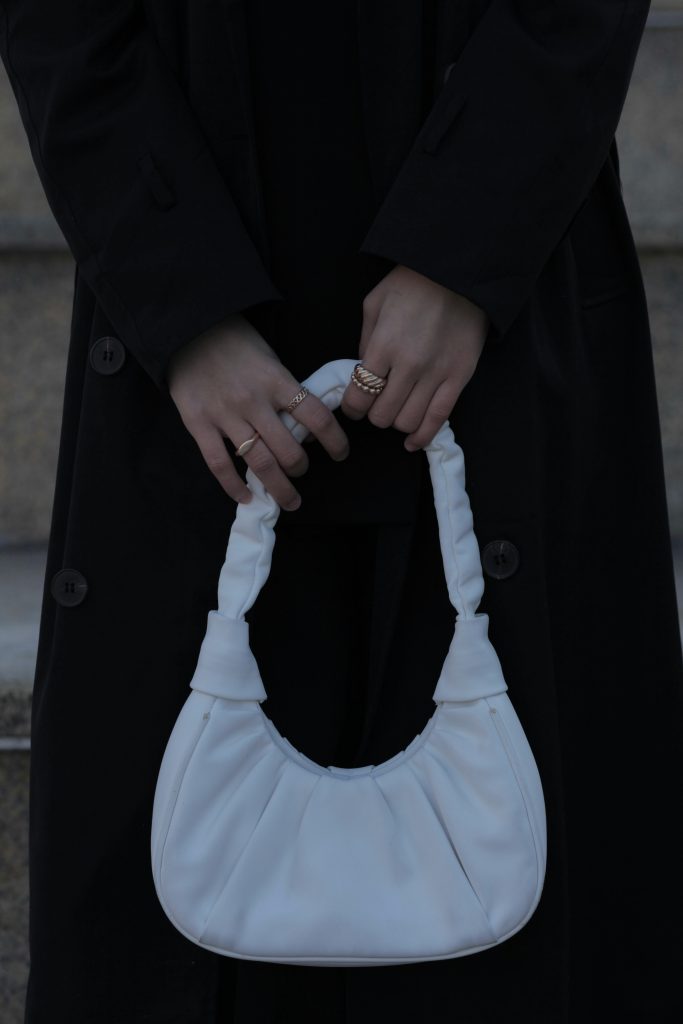 woman holding whit hand bag