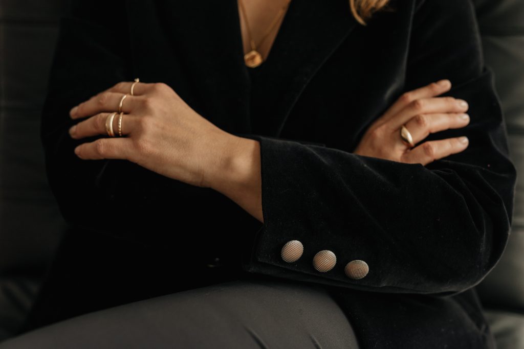 woman in black folding arms