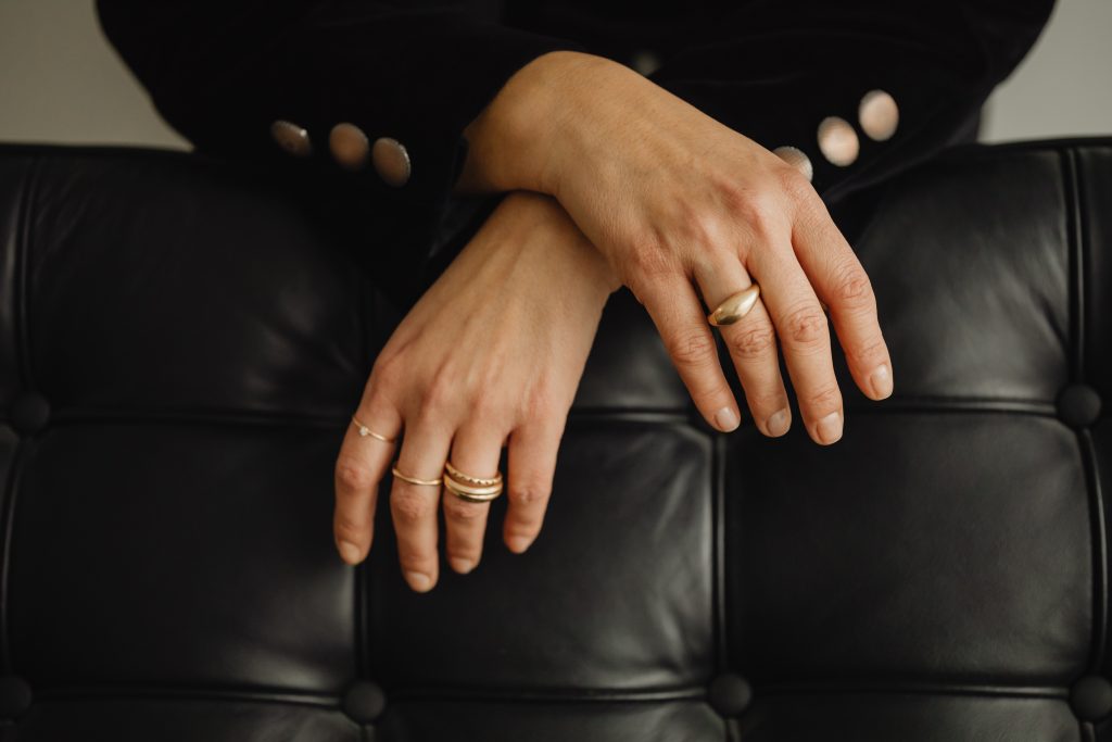 woman in black leaning over chair
