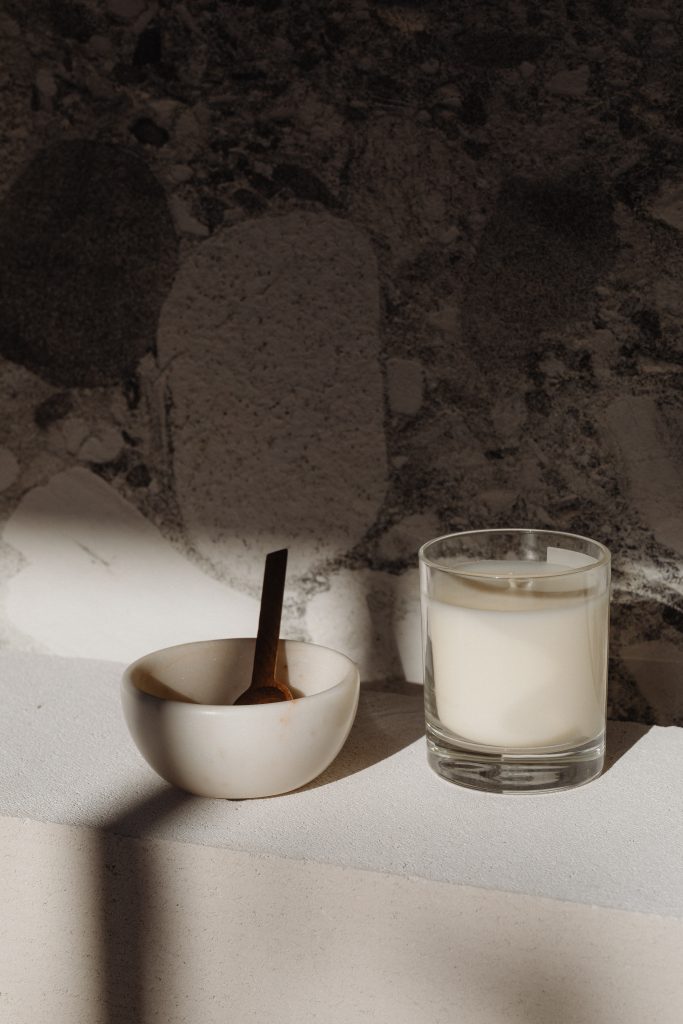 candle and bowl on marble background