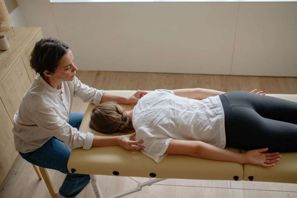 woman in white shirt lying face down on bed
