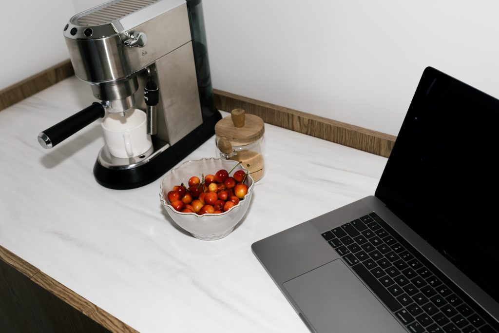 how-to-manage-a-career-with-chronic-illness -laptop- beside-cherries on kitchen work top